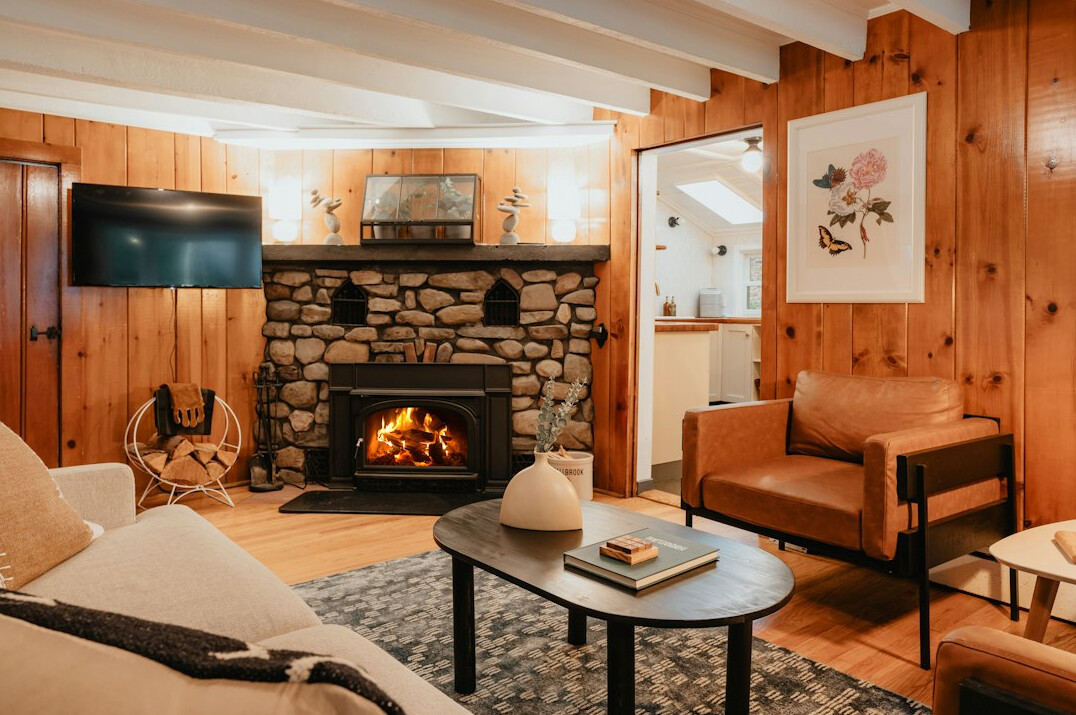 Alpine chalet living room with fireplace and wood beams